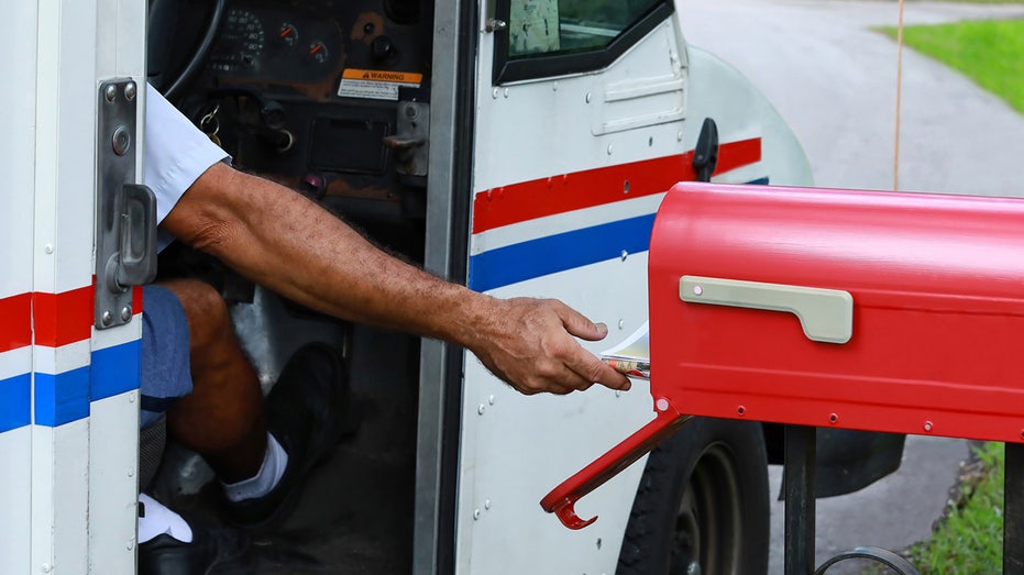 USPS worker at mail box