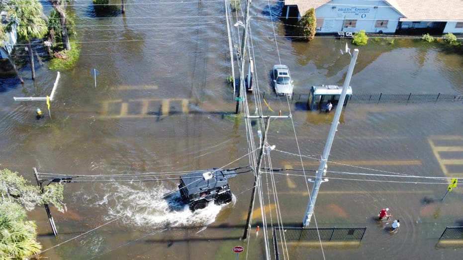 sheriff vehicle driving through flooded area in Tampa