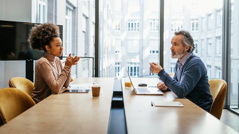 businesspeople sitting across from one another